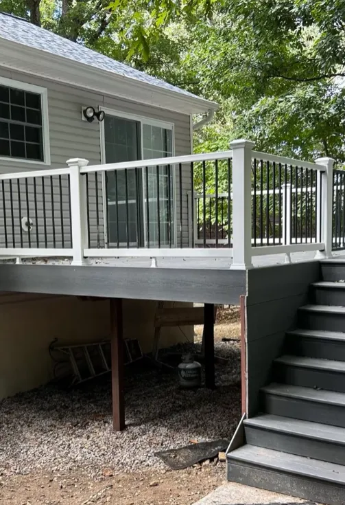 After: composite deck with white posts and black aluminum balusters