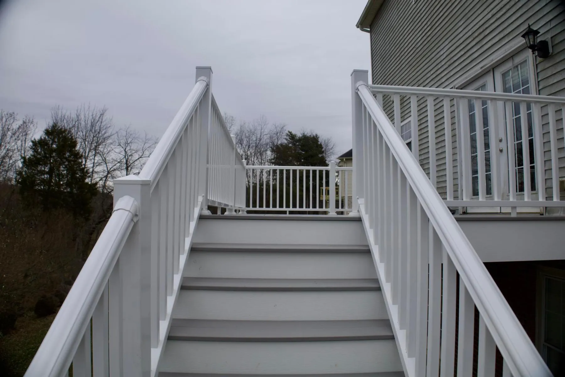 Finished composite stairs with white railings